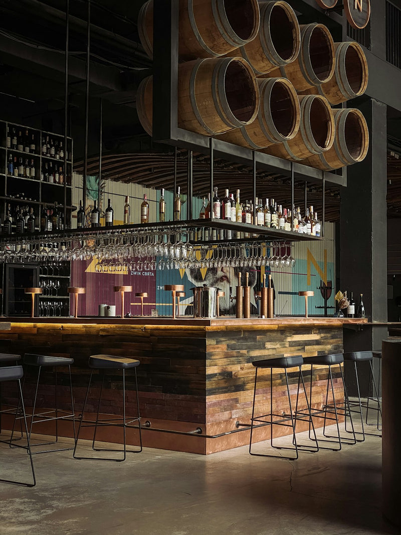 Wooden bar counter with wine bottles