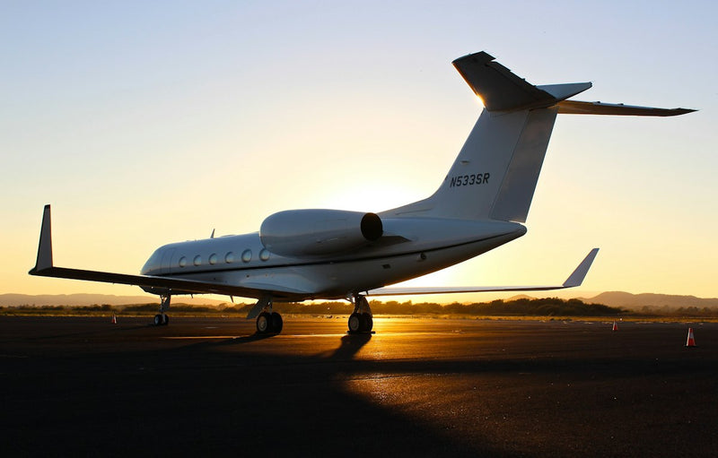 Private jet on the tarmac at sunset